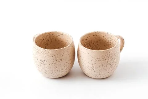Empty beige coffee ceramic cups on isolated white background, cut out Foto stock