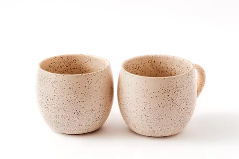 Empty beige coffee ceramic cups on isolated white background, cut out Stock Photos