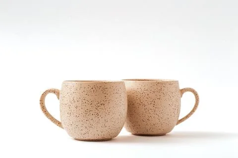 Empty beige coffee ceramic cups on isolated white background, cut out Stock Photos