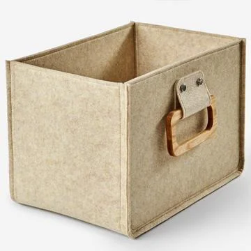Empty beige felt storage box with wooden handle on white background Photos