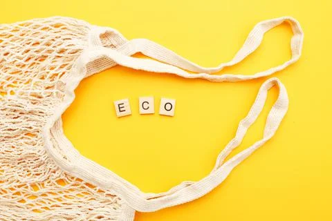 Empty beige reusable string shopping bag on orange background. plastic free 스톡 사진