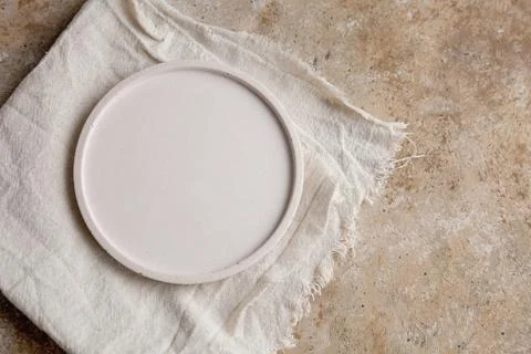 Empty beige Stone platter on conrete table Stock Photos