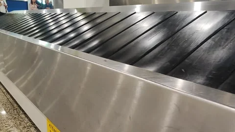 Empty belt for moving hand luggage when passengers claim their luggage. Air trav Stock Footage 287327443