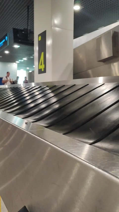 Empty belt for moving hand luggage when passengers claim their luggage. Air trav Stock Footage 287327495
