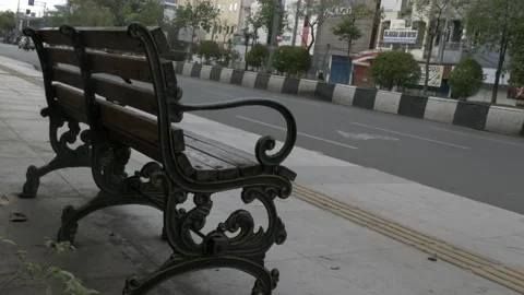 Empty bench with armrest on street sidewalk as public facility Video stock 137420748