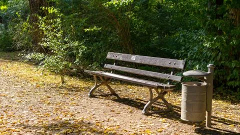 An empty bench during sunset with trash can Stock Photos