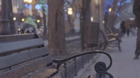Empty bench in evening park with bright christmas decoration light illumination  Stockbeeldmateriaal 132674037