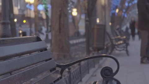 Empty bench in evening park with bright christmas decoration illumination light  Stock Footage 132674042