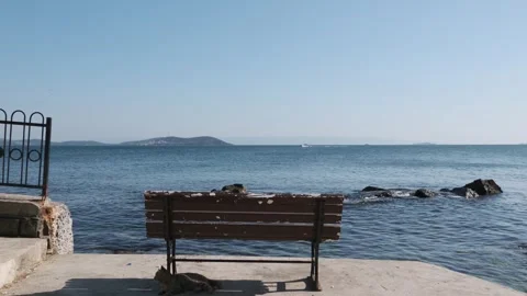 Empty Bench Facing the Ocean on a Sunny Day Stock Footage 279461486