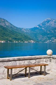 Empty bench on island Gospa od Skrpjela in Perast, Montenegro Stock Photos