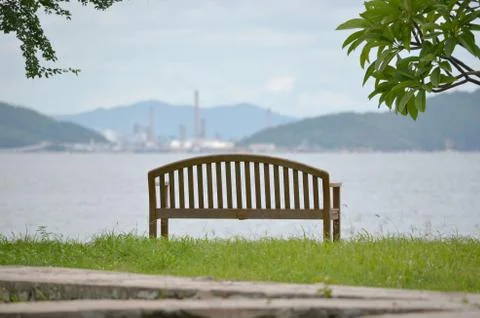 Empty bench looking out to sea Stock Photos