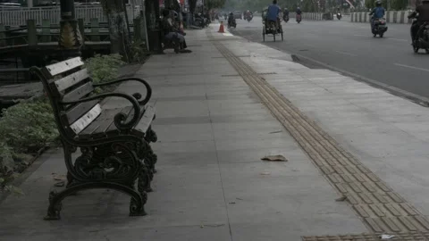 Empty bench made of wood and steel with armrest on street sidewalk Stock Footage 137420000