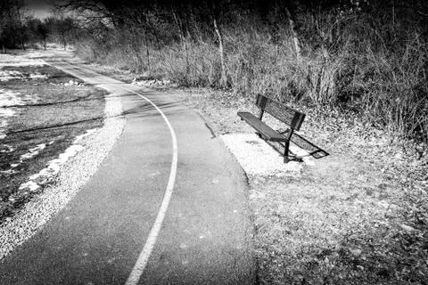 An Empty Bench Near a Trail Stock Photos