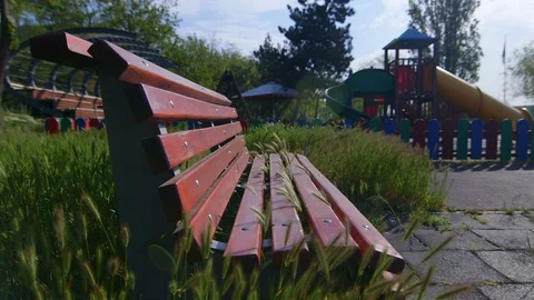 Empty bench at the outdoor playground closed due to pandemic virus Covid-19,  库存影片 129523960