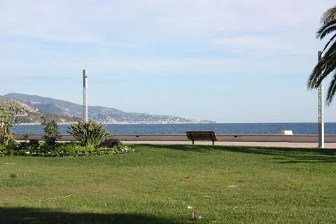 Empty bench over the shore of Menton in Nice Stock Photos