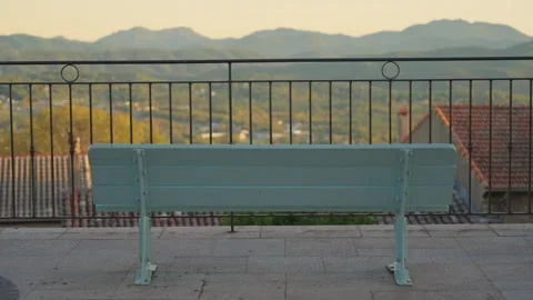 Empty bench overlooking mountain valley at sunset Видео 339183566