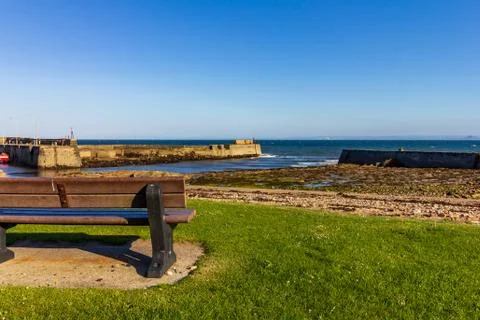Empty bench overlooking St Monans harbor Stock Photos