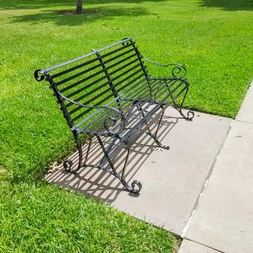Empty bench in park on bright day Stock-Fotos