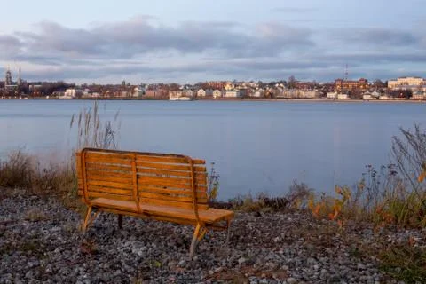 Empty bench by the river Stock Photos