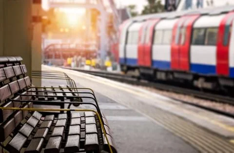 Empty bench on a train station platform Stock Photos