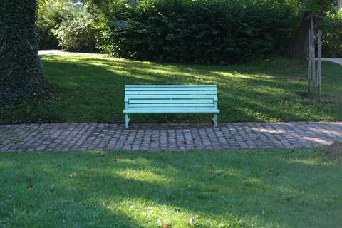 Empty bench under trees in the Park of Bercy in Paris, France Stock Photos