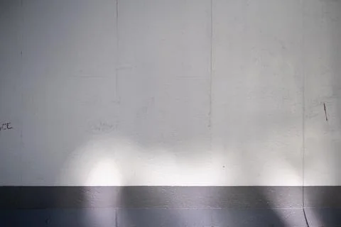 Empty Berlin Wall graffiti mockup. Grey concrete wall with sun light and shadows Stock Photos