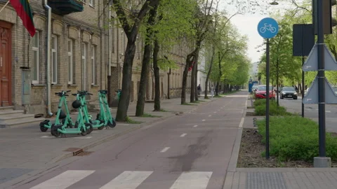 Empty Bicycle Lane and Electric Scooters Parked on a Street in Vilnius Vídeo Stock 334770803