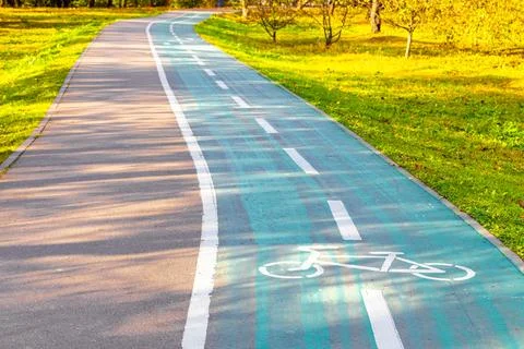 Empty bicycle path with markings in a city park Stock Photos