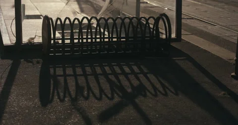 Empty Bicycle Rack Casting Shadows at Tram Stop in Zagreb Stock-Footage 336029749