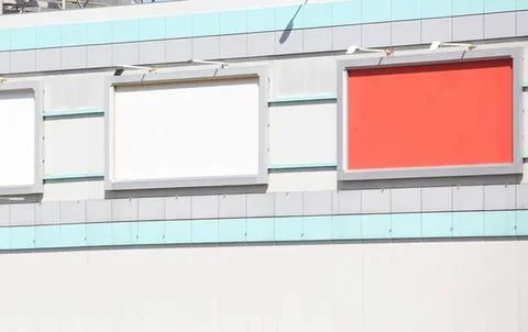 Empty billboard frames on building wall with blue and white panels Stock Photos