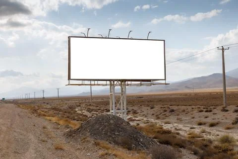 Empty billboard stands against a cloudy sky in a remote area Stock Photos