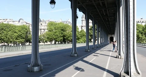 Empty Bir Hakeim bridge in Paris, perspective view with people cycling in France Stock Footage 124583431