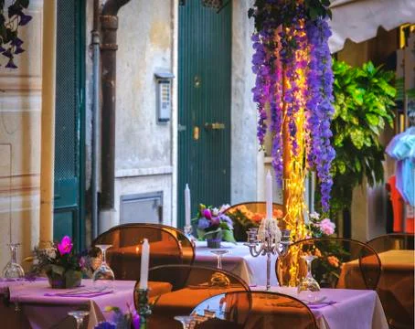 Empty bistro dinner first date restaurant design romantic outdoor purple flowers Stock Photos