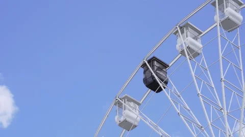 Empty black and white ferris wheel cabins swinging in an amusement park Video stock 308044194