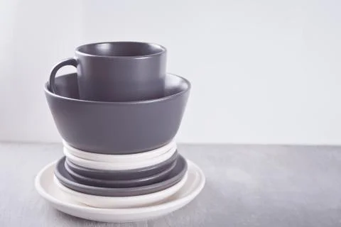 Empty black and white plates over gray table. Stock Photos