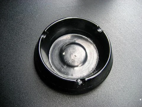 Empty Black Ashtray on an iron table Stock Photos