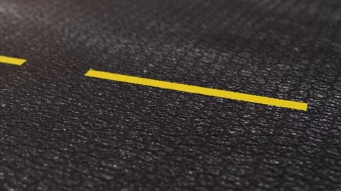 Empty black asphalt road with yellow lines close up shot. Stock Footage 108969370