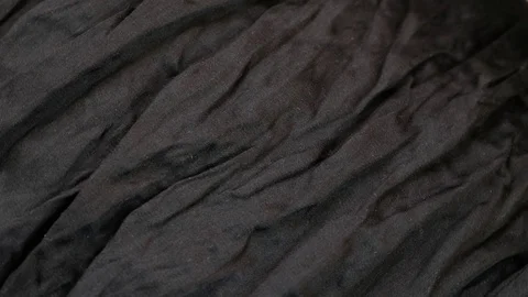 Empty black background with wrinkle texture rotating Stock Footage 128058983