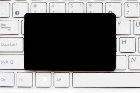 Empty black blank card on computer keyboard Foto stock