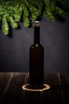 Empty black bottle of wine, under a ray of light, on a black background with  Stock Photos