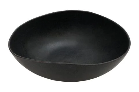 Empty black bowl made of ceramic on white background. Modern kitchenware fo.. Stockfoto's