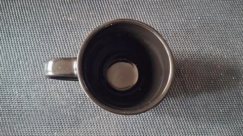 Empty black ceramic coffee mug viewed from a high angle perspective Stock Photos