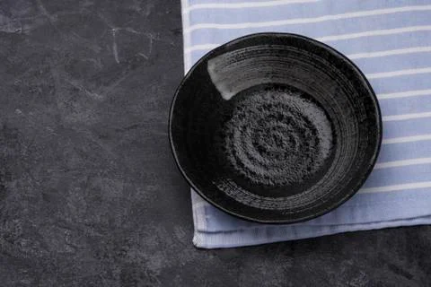 Empty black ceramic plates on a dark black table - top view. Stock Photos