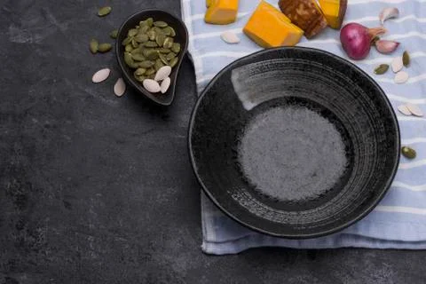 Empty black ceramic plates on a dark black table - top view. Stock Photos