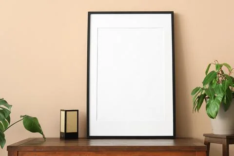 Empty black frame with white mat on a wooden dresser, modern home decor and i Stock Photos