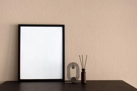 Empty black frame with white space on a dark table, modern home decor and aro Stock Photos
