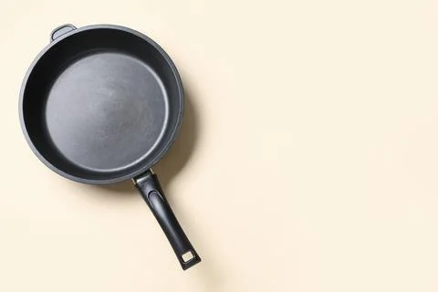 Empty black frying pan with non-stick coating and handle, kitchen cookware fo Stock Photos