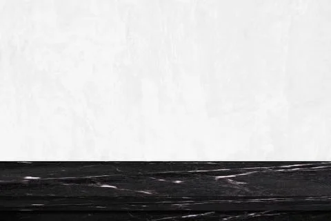 Empty black marble table over white cement wall background Stock Photos