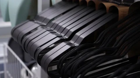 Empty black plastic hangers for clothes on the counter of the store. Stock Footage 232855207