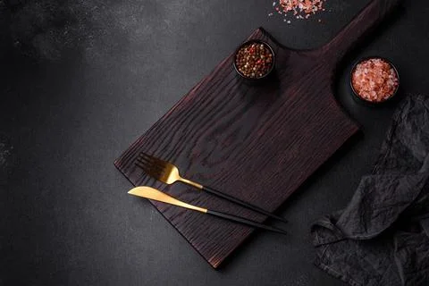 Empty black plate over dark stone background with free space. Top view Stock Photos